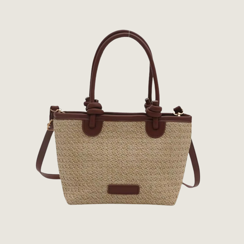 Bolsa de palha Carafori com alça superior em couro marrom, design sofisticado e versátil.